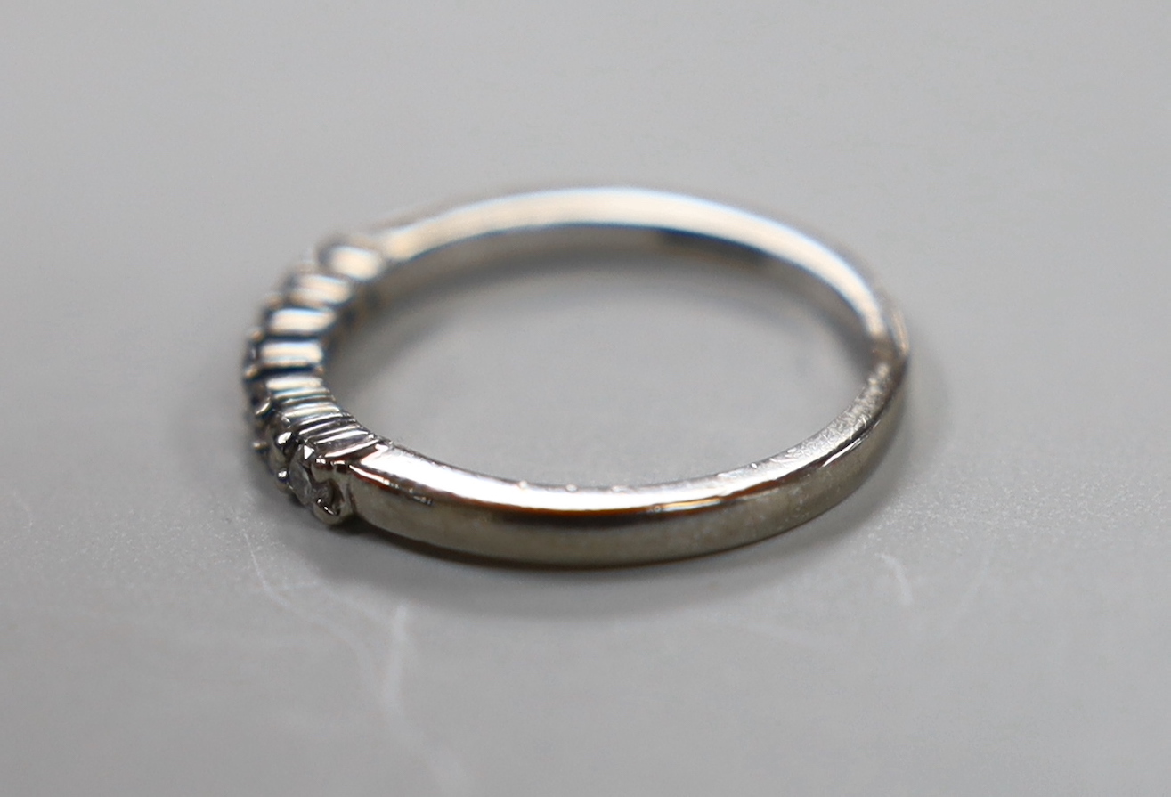 A modern 18ct white gold and seven stone diamond chip set half hoop ring, size K, gross weight 2.4 grams.